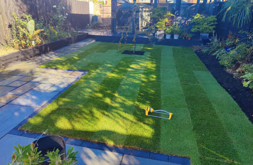 Garden makeover featuring porcelain, composite decking, and Venetian fencing for a stylish outdoor space