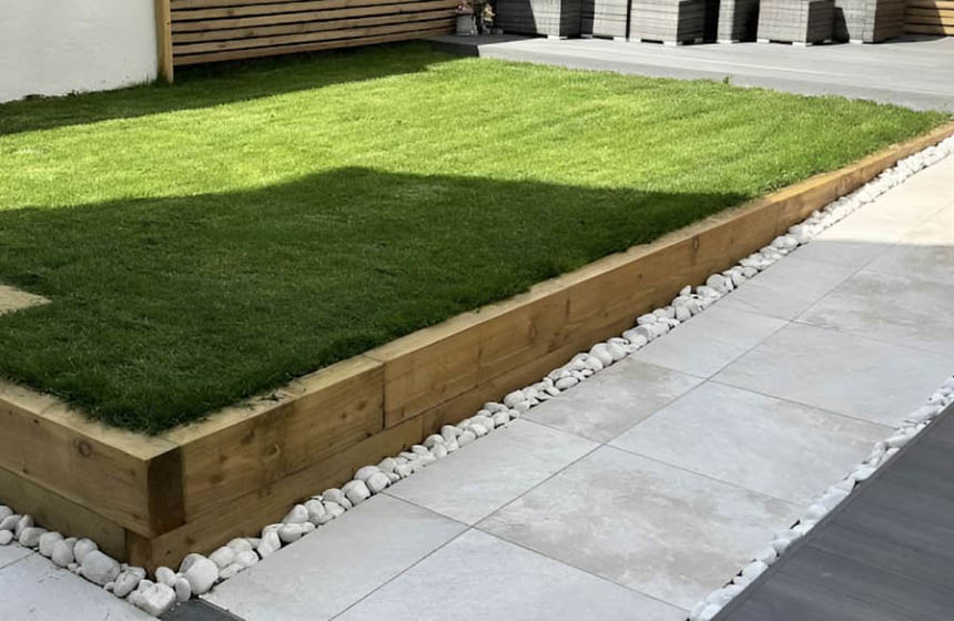 Garden makeover featuring porcelain, composite decking, and Venetian fencing for a stylish outdoor space