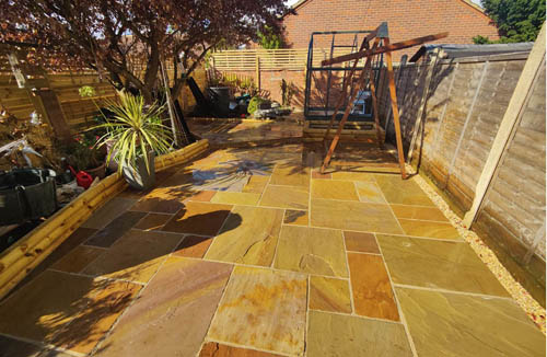 Chic camel dust sandstone with raised rounded sleepers for a modern and contemporary outdoor garden look